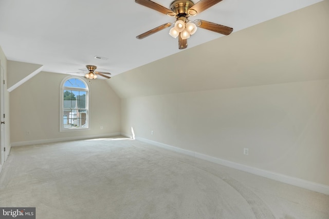 additional living space with light colored carpet, vaulted ceiling, and ceiling fan