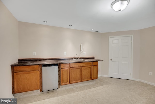 kitchen with light tile patterned floors, sink, and stainless steel appliances