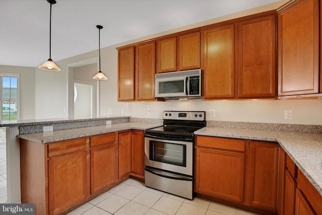 kitchen featuring light stone countertops, kitchen peninsula, decorative light fixtures, light tile patterned flooring, and appliances with stainless steel finishes