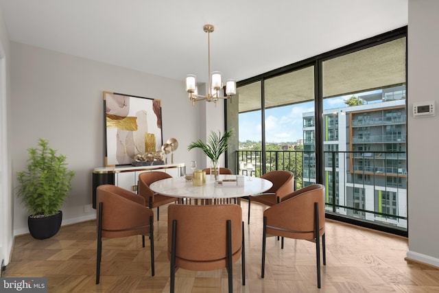 dining room featuring light parquet flooring and a notable chandelier