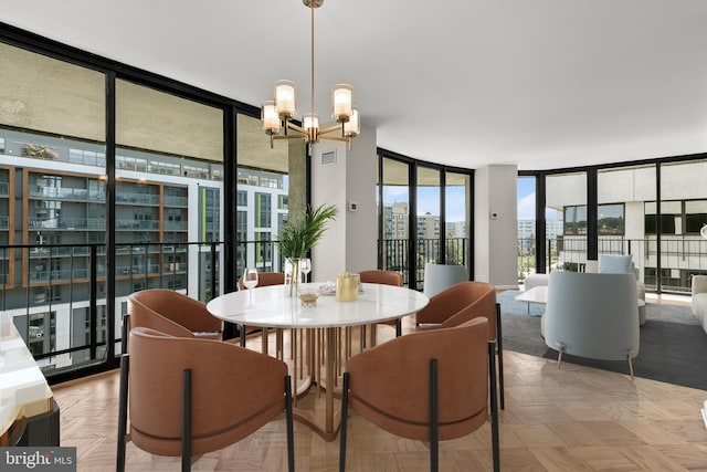 dining room with a notable chandelier and a wall of windows