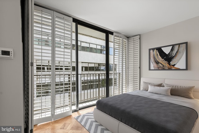 bedroom featuring access to exterior and light parquet flooring