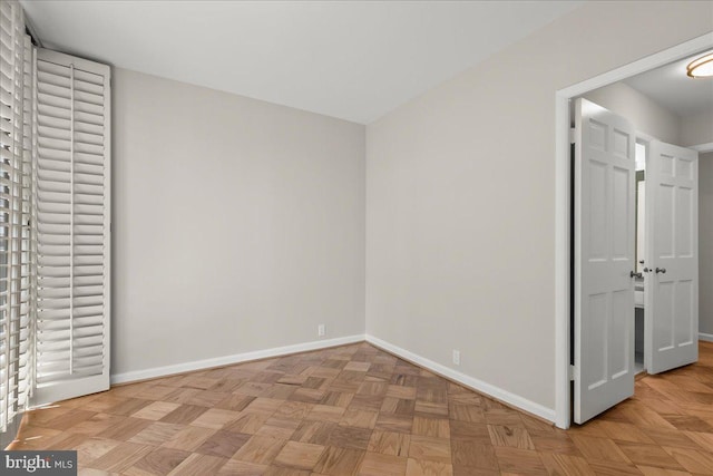 unfurnished bedroom featuring light parquet flooring