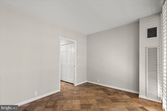 unfurnished bedroom with a closet and light parquet flooring