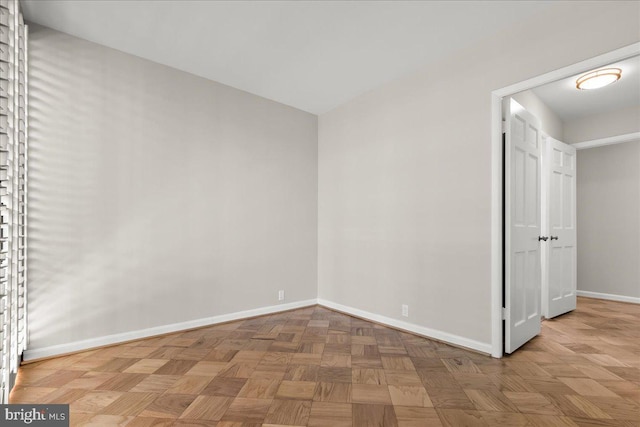 unfurnished room featuring parquet floors