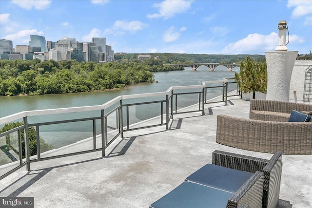 view of patio with a water view and a balcony