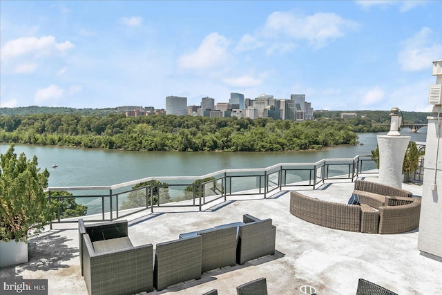 view of patio / terrace with an outdoor living space and a water view