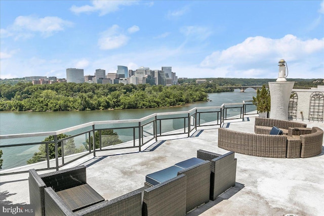 view of patio featuring a balcony and a water view