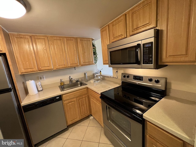 kitchen featuring sink, light tile floors, and stainless steel appliances