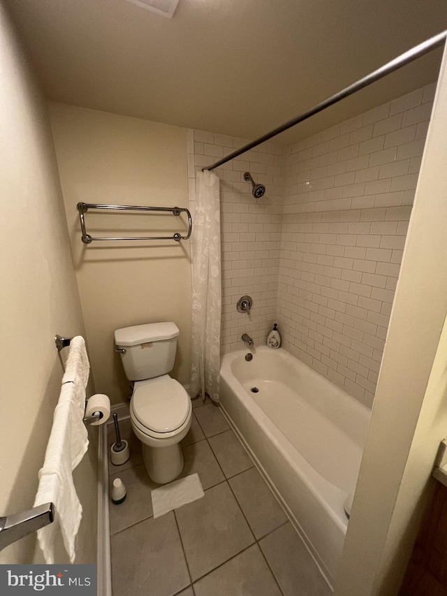 bathroom with tile floors, shower / bath combination with curtain, and toilet