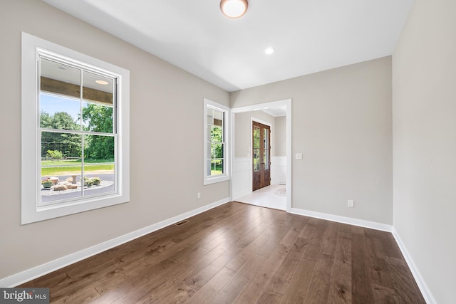 spare room featuring dark hardwood / wood-style flooring