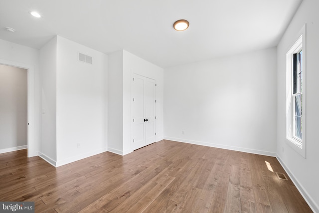 empty room with wood-type flooring