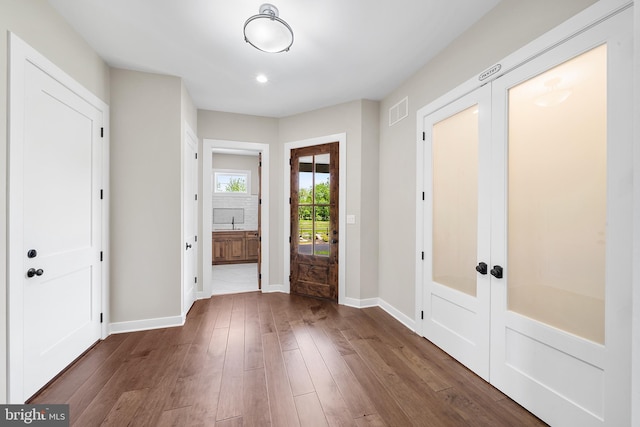 entrance foyer with french doors and dark hardwood / wood-style floors