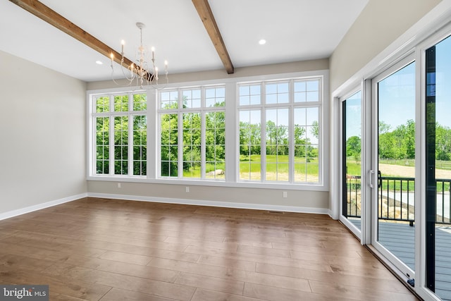 unfurnished sunroom with beam ceiling and a notable chandelier