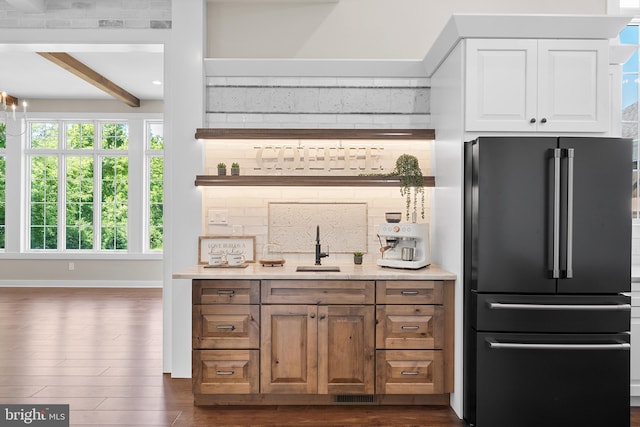 kitchen featuring high quality fridge, dark wood-type flooring, beamed ceiling, backsplash, and sink