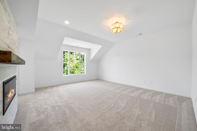 additional living space with lofted ceiling and light carpet