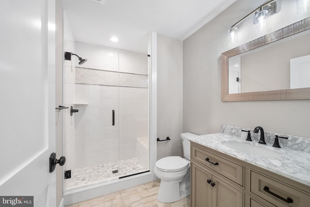 bathroom with a shower with door, tile flooring, toilet, and vanity