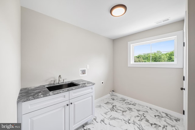 washroom with cabinets, light tile flooring, electric dryer hookup, hookup for a washing machine, and sink