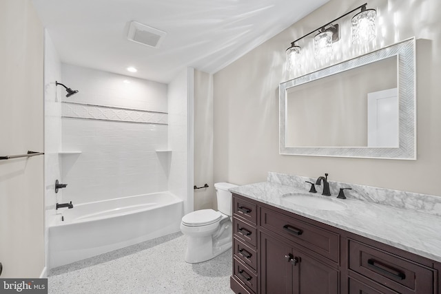 full bathroom with tiled shower / bath, vanity, and toilet