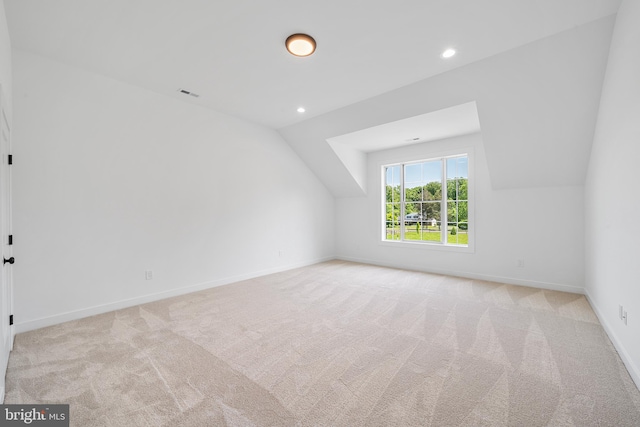 additional living space with lofted ceiling and light colored carpet