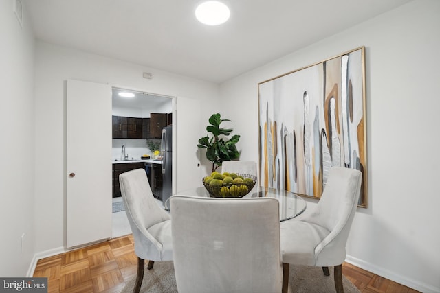 dining room with light parquet floors and sink