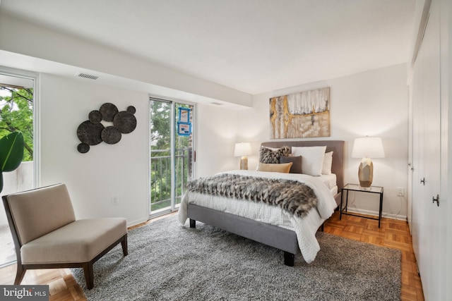 bedroom featuring parquet flooring and access to outside