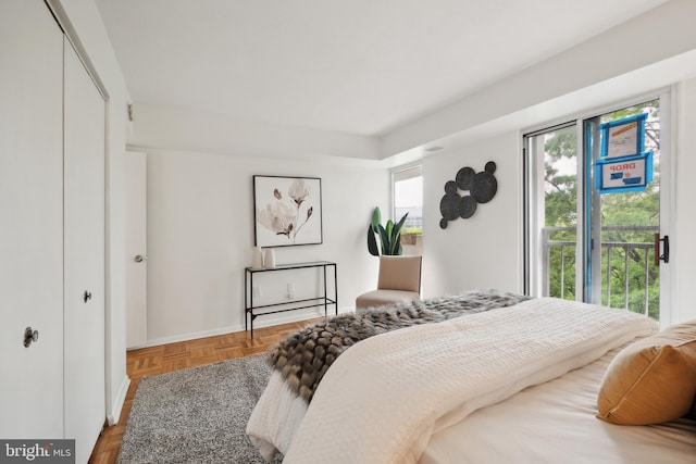 bedroom featuring a closet and parquet floors