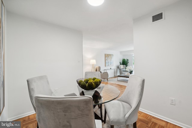 dining area featuring light parquet floors