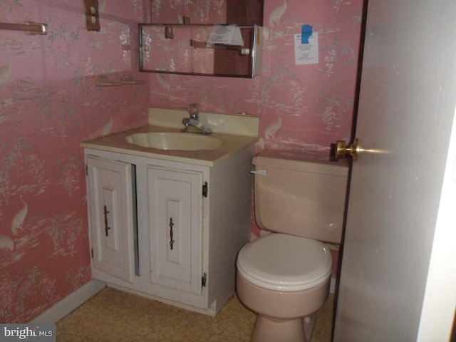 bathroom featuring toilet and vanity