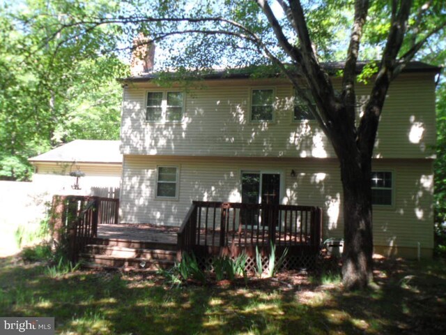 rear view of house featuring a deck