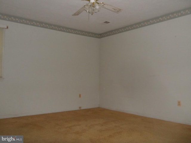 spare room featuring carpet and ceiling fan