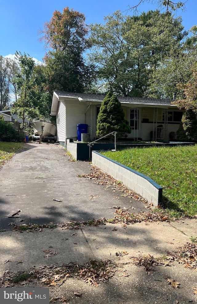 exterior space featuring covered porch and a lawn