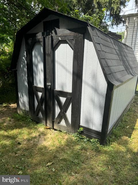 view of outbuilding with a yard