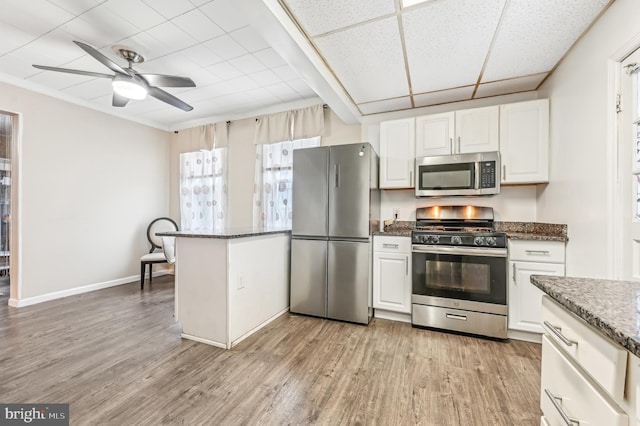 kitchen with white cabinetry, ceiling fan, dark stone counters, light hardwood / wood-style floors, and appliances with stainless steel finishes