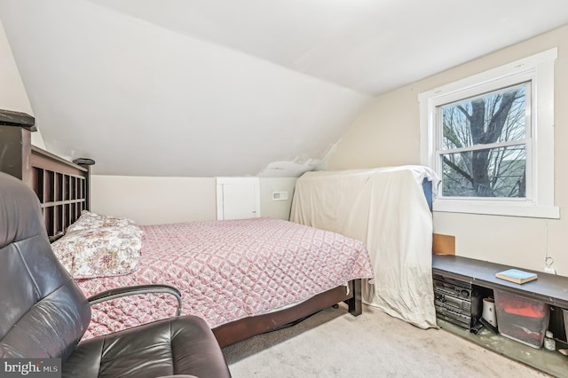 bedroom with carpet and lofted ceiling