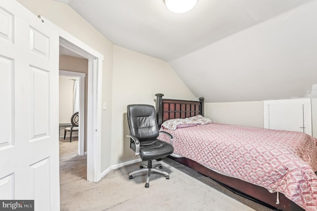 bedroom featuring carpet floors and lofted ceiling