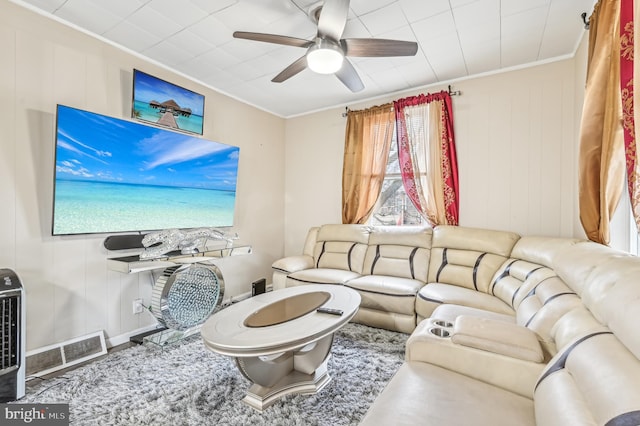 living room featuring ceiling fan and ornamental molding