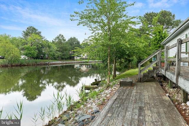 wooden terrace featuring a water view