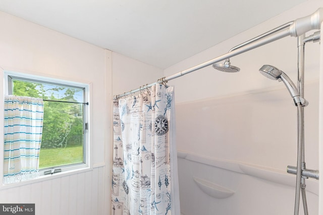 bathroom featuring a shower with curtain and a healthy amount of sunlight