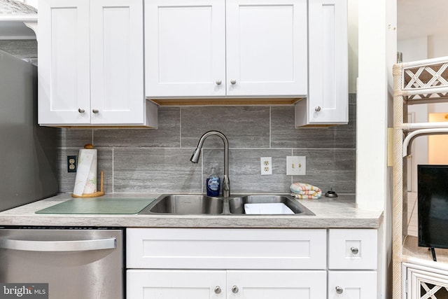 kitchen with white cabinetry, sink, backsplash, and stainless steel dishwasher