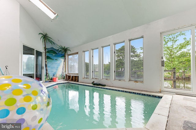 view of swimming pool featuring a skylight