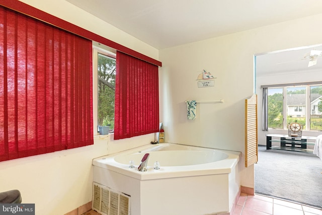 bathroom with tile floors, a bathtub, and ceiling fan