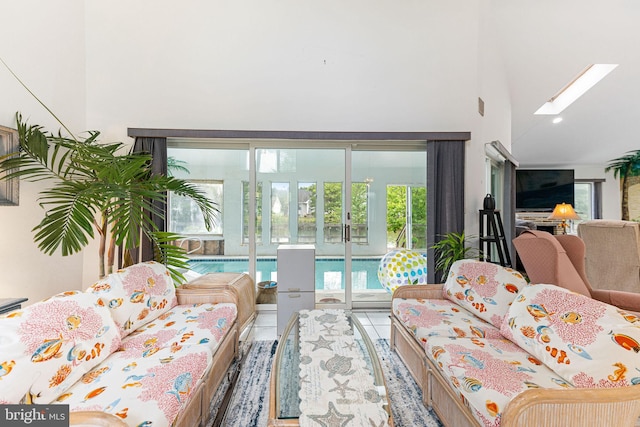 living room featuring a high ceiling and a skylight