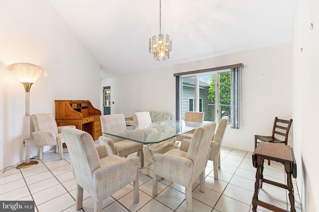 dining area featuring an inviting chandelier, light tile flooring, and lofted ceiling