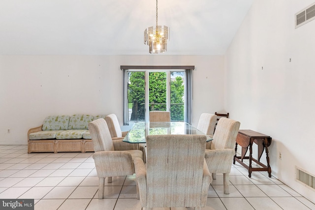 dining area with light tile floors and an inviting chandelier