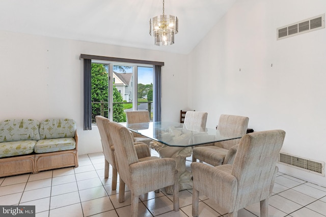 tiled dining space featuring vaulted ceiling and an inviting chandelier