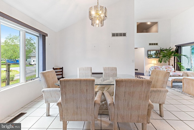 dining space featuring high vaulted ceiling, an inviting chandelier, and light tile floors