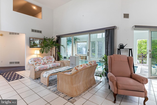 tiled living room with a high ceiling