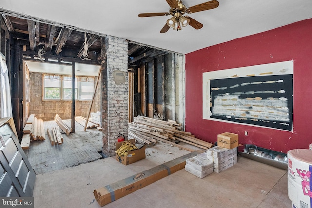 miscellaneous room with ceiling fan and concrete floors