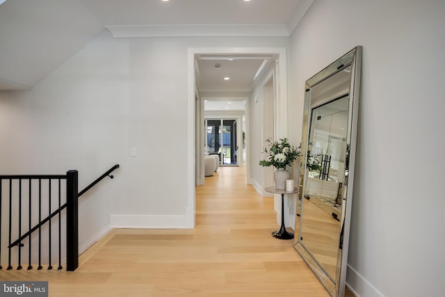 7013 Raleigh Rd, Annandale, VA 22003 - hallway with an upstairs landing, light wood finished floors, baseboards, ornamental molding, and recessed lighting